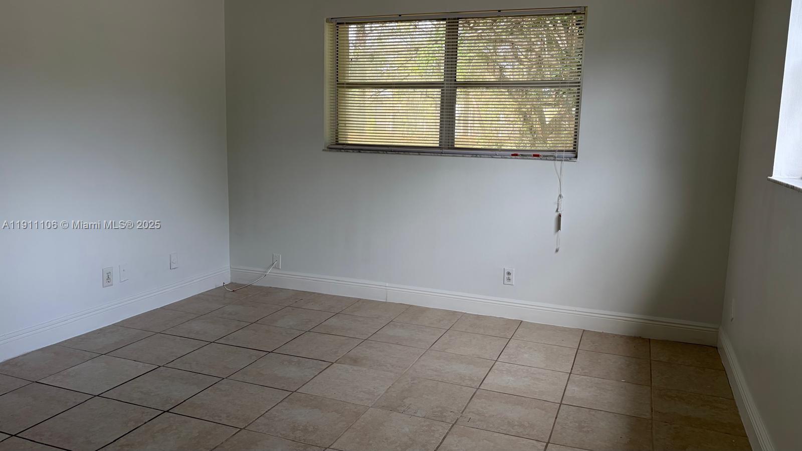 7925 Fairview Drive, Unit 110 Tamarac, FL 33321 - Photo 15 of 34 an empty room with windows