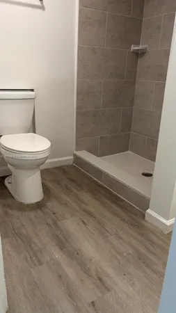 a bathroom with a toilet and a shower