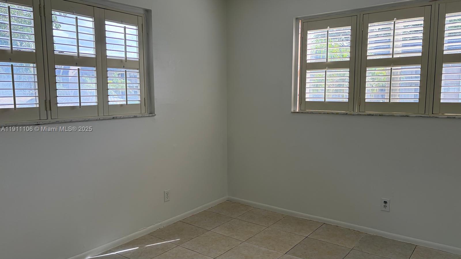 7925 Fairview Drive, Unit 110 Tamarac, FL 33321 - Photo 21 of 34 an empty room with a window
