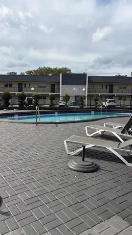 a view of a backyard and entertaining space