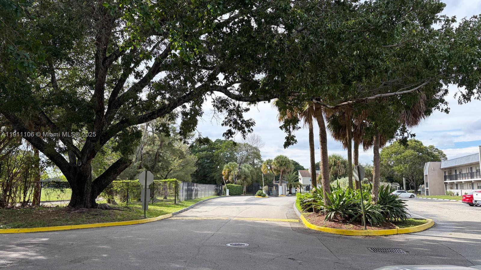 7925 Fairview Drive, Unit 110 Tamarac, FL 33321 - Photo 30 of 34 a view of road with palm trees