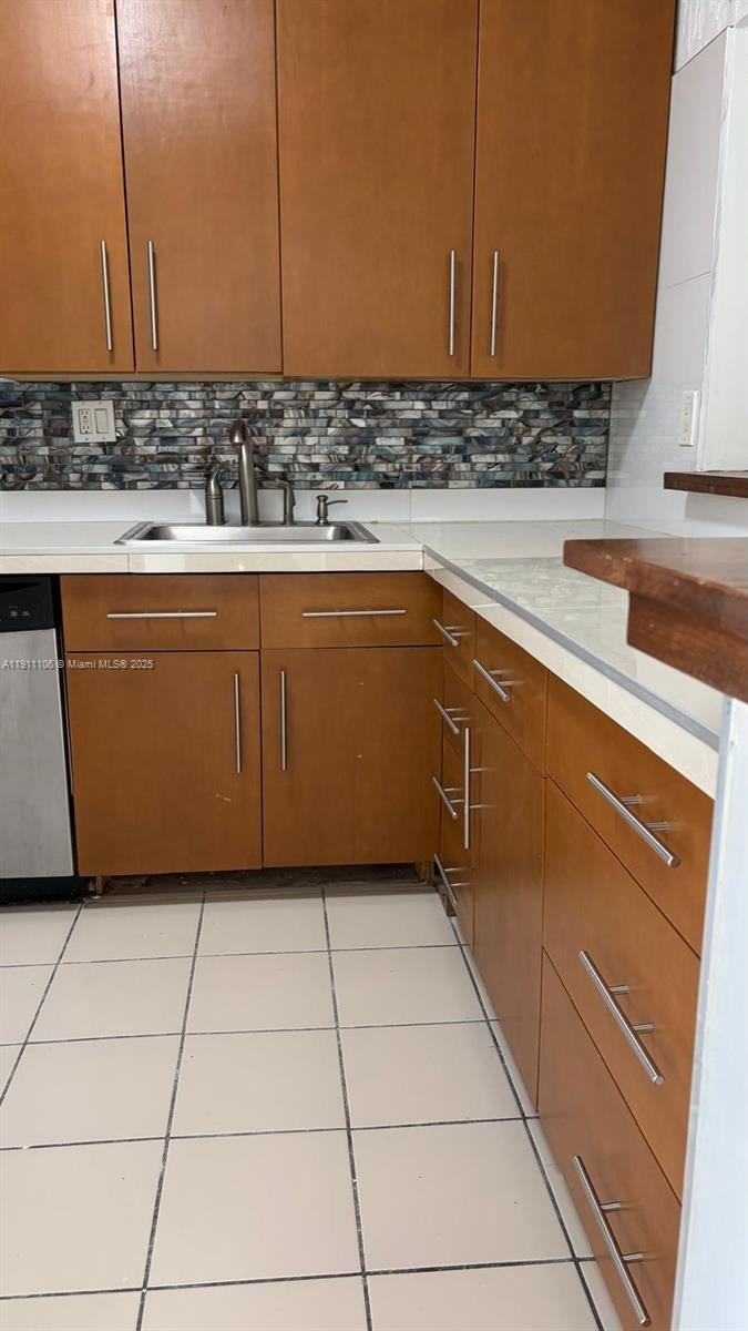 7925 Fairview Drive, Unit 110 Tamarac, FL 33321 - Photo 4 of 34 a kitchen with stainless steel appliances granite countertop a sink and cabinets