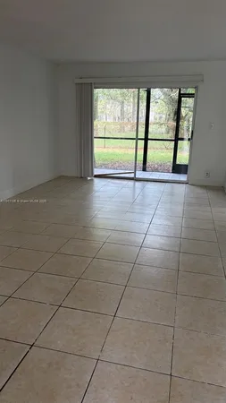 an empty room with large windows