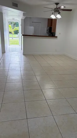 a view of a kitchen with an empty space and a window