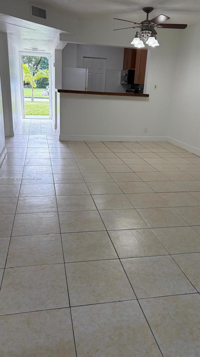 7925 Fairview Drive, Unit 110 Tamarac, FL 33321 - Photo 7 of 34 a view of a kitchen with an empty space and a window