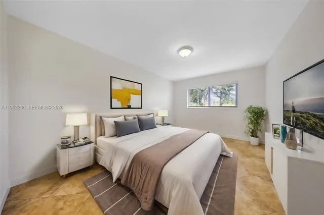 a bedroom with a bed and a flat screen tv