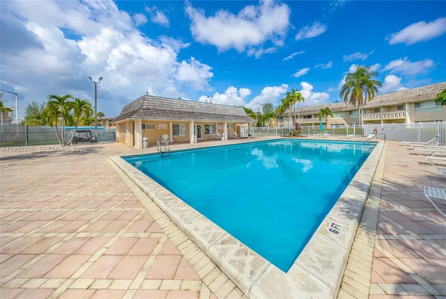 a view of a house with a swimming pool and a chairs