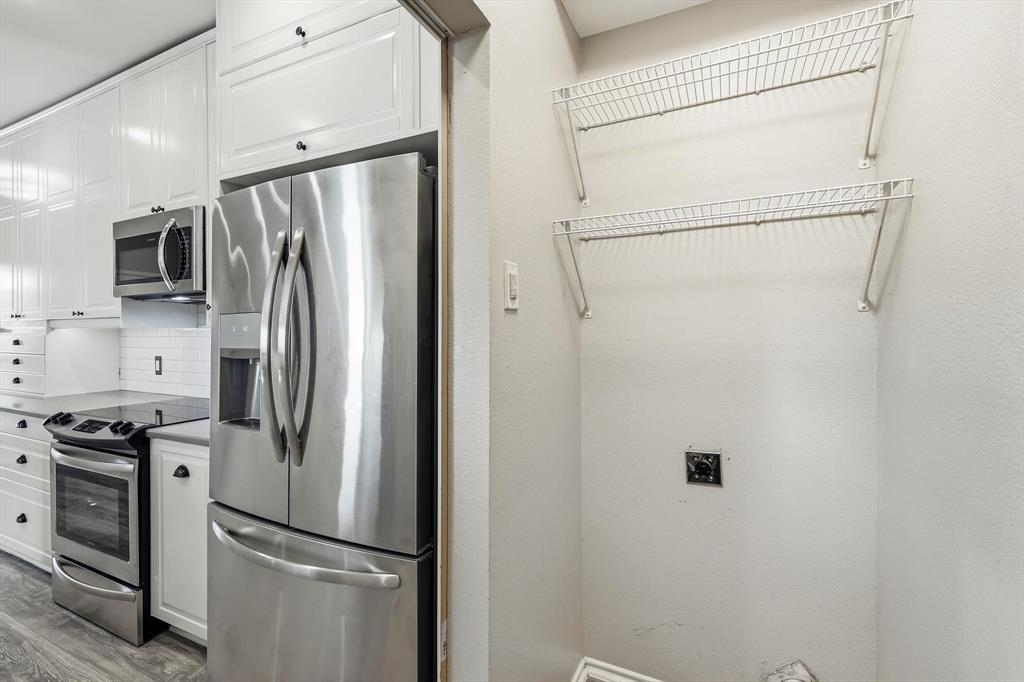 2917 Roxboro Road Euless, TX 76039 - Photo 12 of 24 Refrigerator will stay for tenant use. Full washer and dryer area.