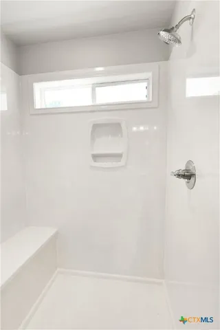 a bathroom with a bathtub and a toilet
