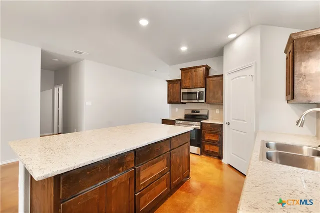 a view of a kitchen with a sink and a window