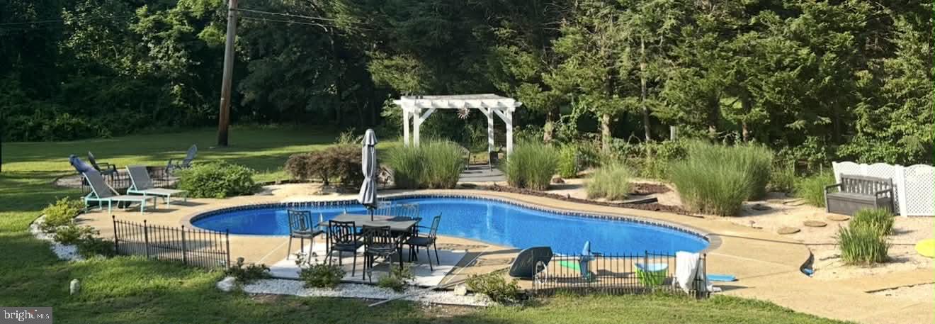 1054 Bayard Road Lothian, MD 20711 - Photo 6 of 6 a swimming pool with outdoor seating and yard
