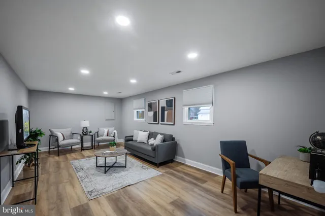 a living room with furniture and wooden floor