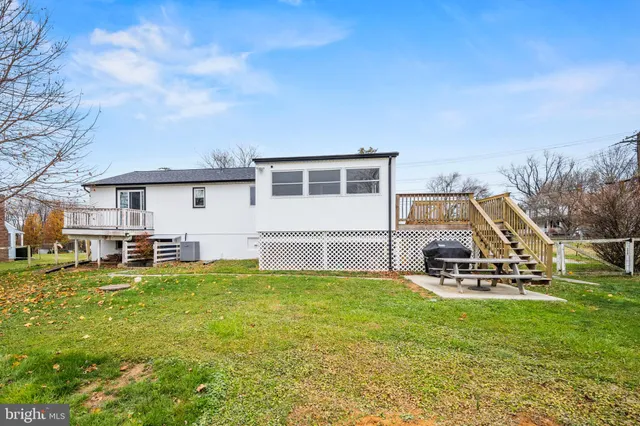 a view of a house with a yard porch and sitting area