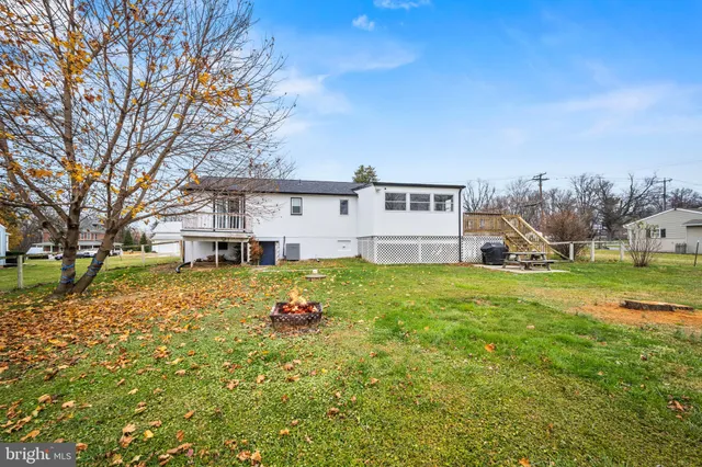 a view of a house with backyard and a sitting area