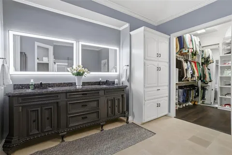 a spacious bathroom with a granite countertop sink and a mirror