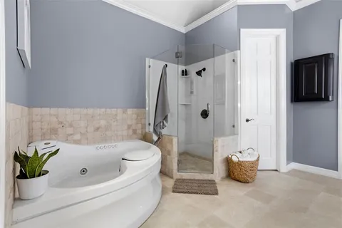 a bathroom with a tub shower and a sink