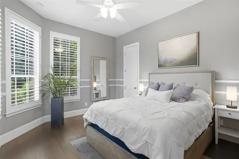 a bedroom with a large bed and a chandelier