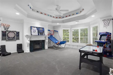 a living room with furniture a fireplace and a large window