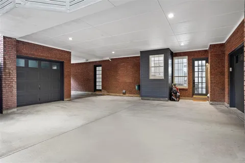 a view of a hallway with wooden floor and windows