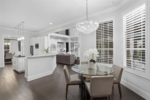 a view of a dining room with furniture wooden floor and chandelier