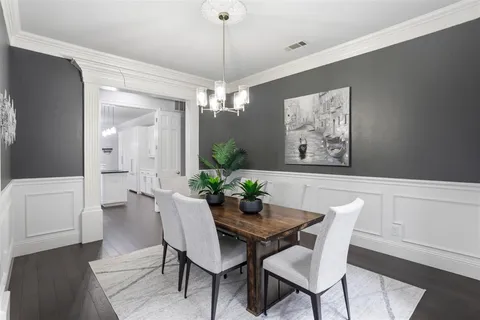 a view of a dining room with furniture and chandelier