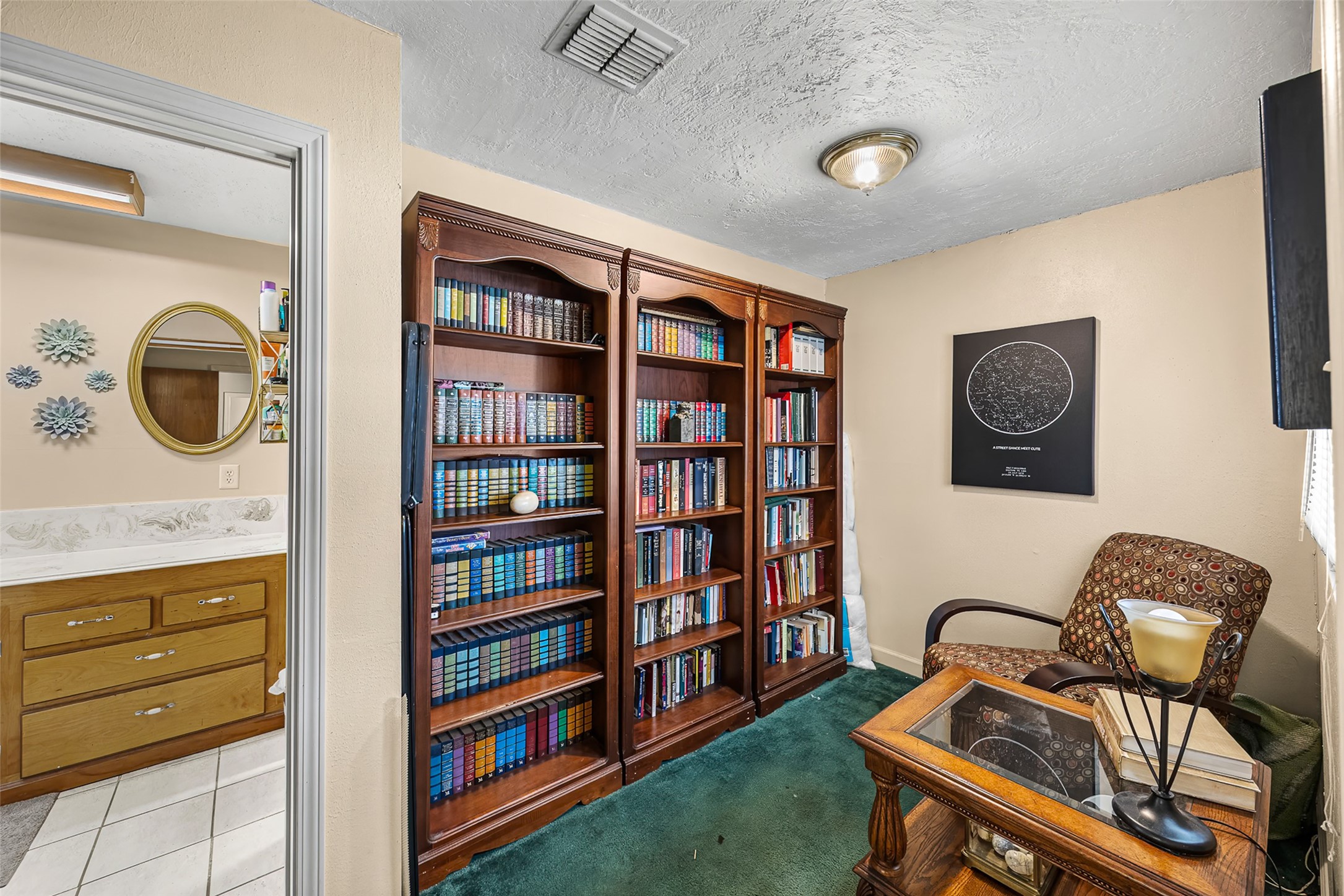 2519 Wood River Road Spring, TX 77373 - Photo 10 of 26 a living room with fish tank and a bookshelf