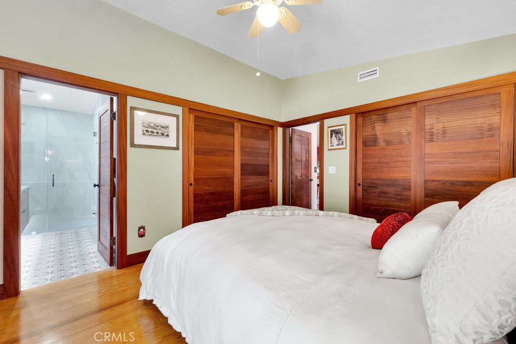 171 Comanche Topanga, CA 90290 - Photo 15 of 54 a bedroom with a large bed and a chandelier