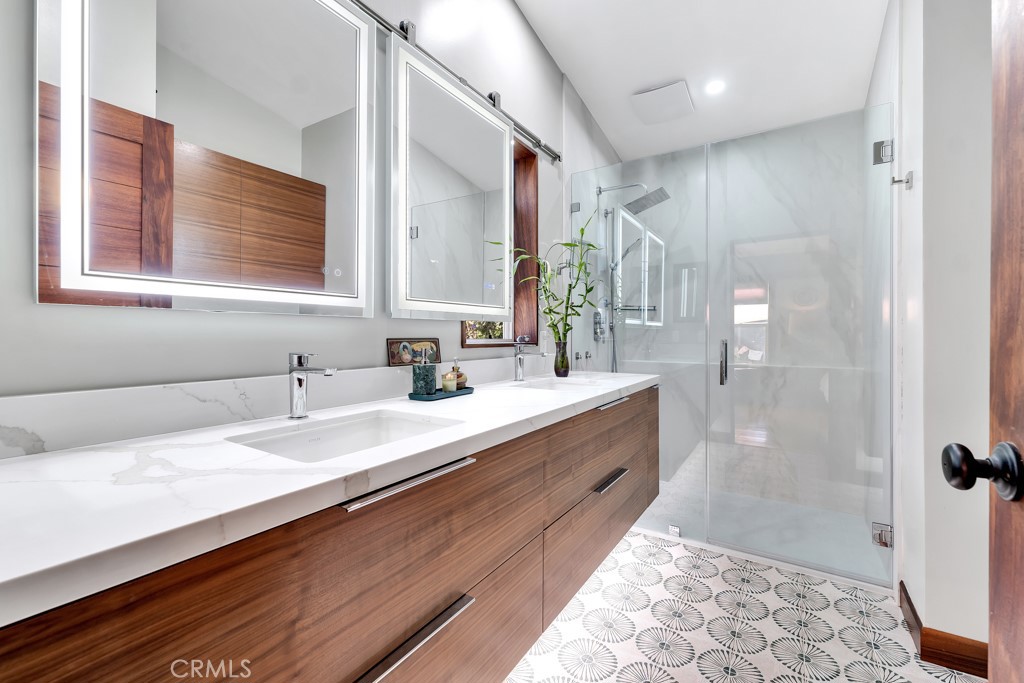 171 Comanche Topanga, CA 90290 - Photo 16 of 54 a bathroom with a double vanity sink a mirror and a shower