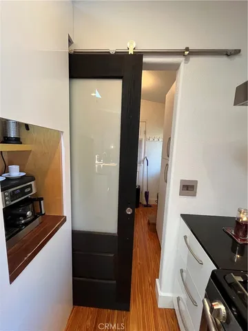 a kitchen with a refrigerator and a stove