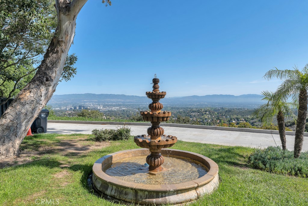 171 Comanche Topanga, CA 90290 - Photo 30 of 54 a vase of water sitting on a table with a lake view