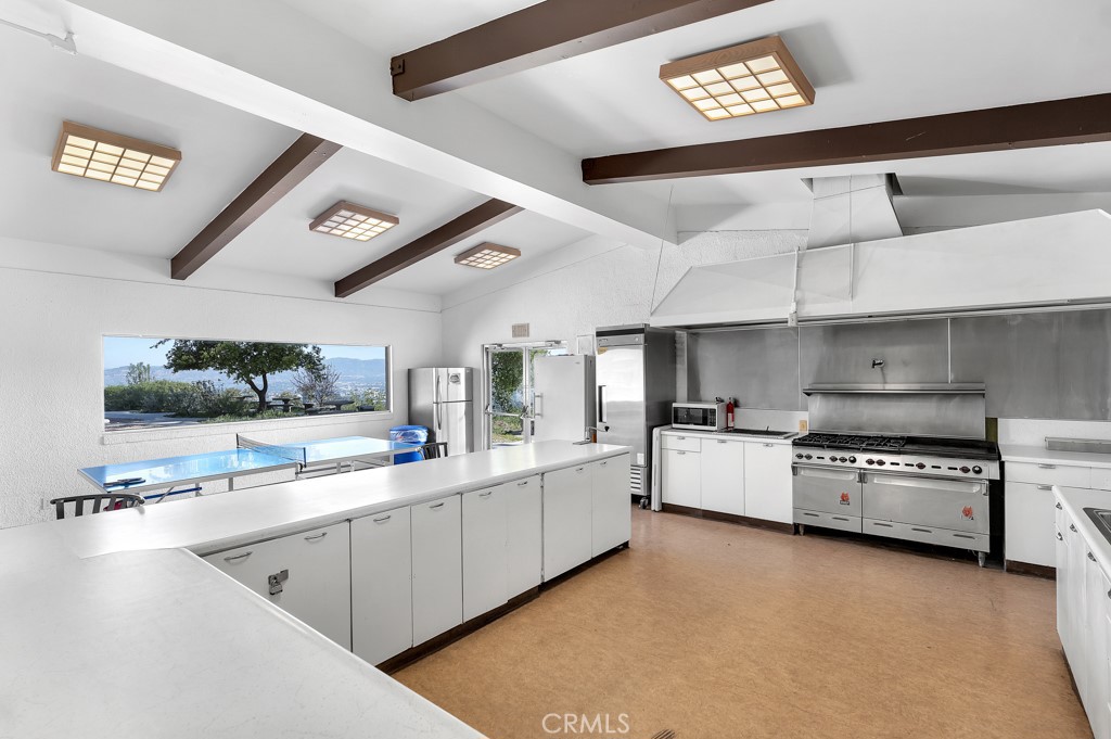 171 Comanche Topanga, CA 90290 - Photo 33 of 54 a kitchen with stainless steel appliances and white cabinets