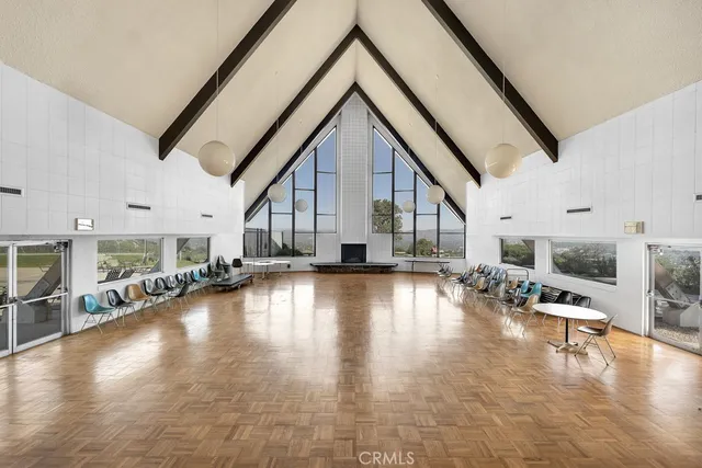 a view of a room with furniture and a chandelier