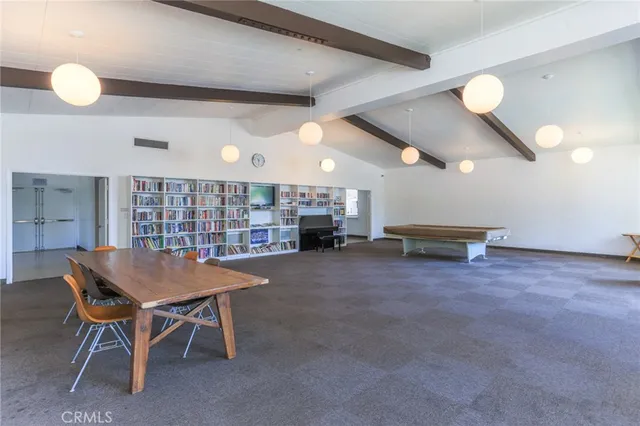 a view of a backyard with table and chairs plants and large trees