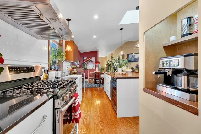 a kitchen with stainless steel appliances granite countertop a stove and a refrigerator