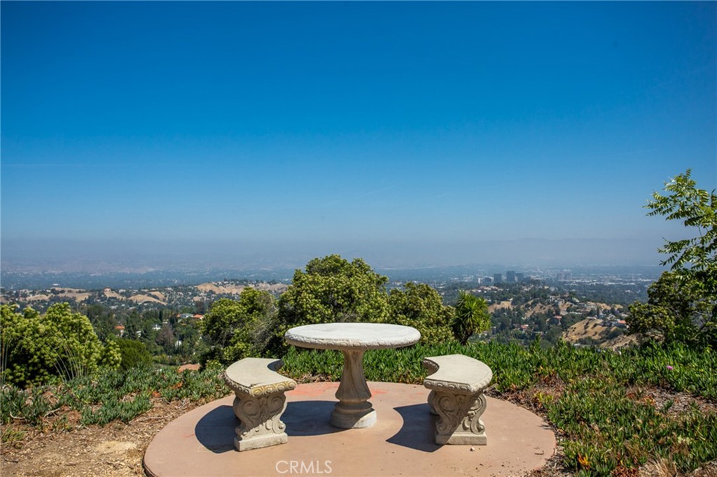 171 Comanche Topanga, CA 90290 - Photo 42 of 54 a view of a backyard with table and chairs plants and large trees