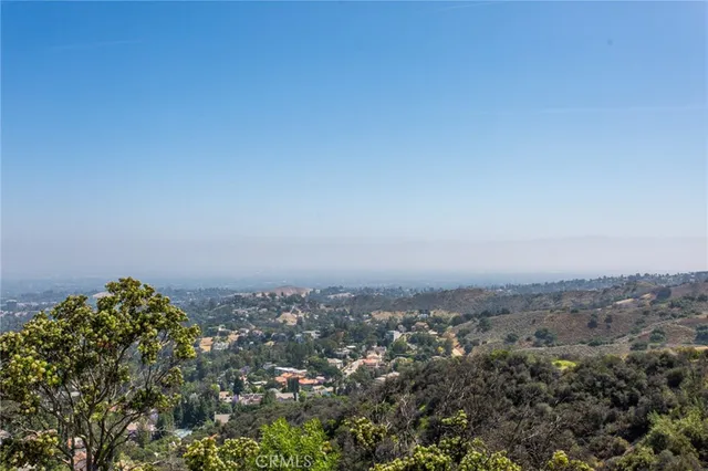 an aerial view of a house with swimming pool and lake view