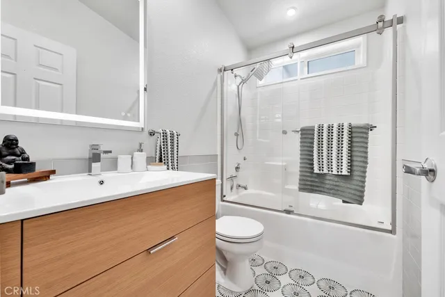 a bathroom with a sink mirror toilet and bathtub