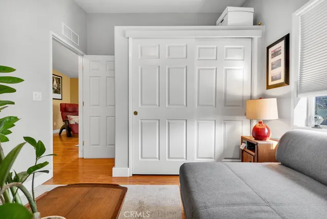 a bed room with a bed and a potted plant