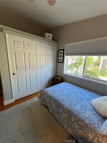 a spacious bedroom with a bed and a window