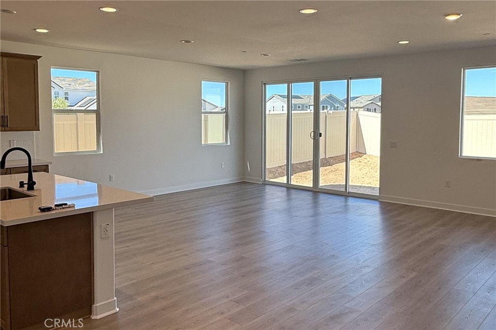 17454 Marion Mountain Hesperia, CA 92345 - Photo 3 of 11 a view of an empty room with wooden floor and a window