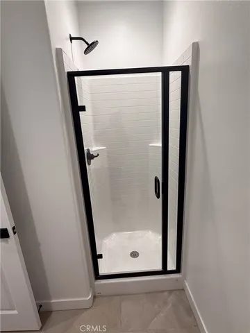 a bathroom with a glass shower door