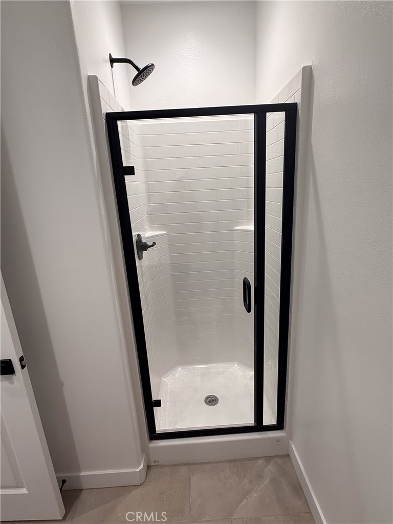 17454 Marion Mountain Hesperia, CA 92345 - Photo 8 of 11 a bathroom with a glass shower door