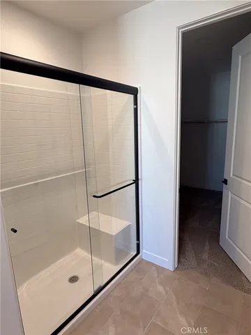 a bathroom with a glass shower door