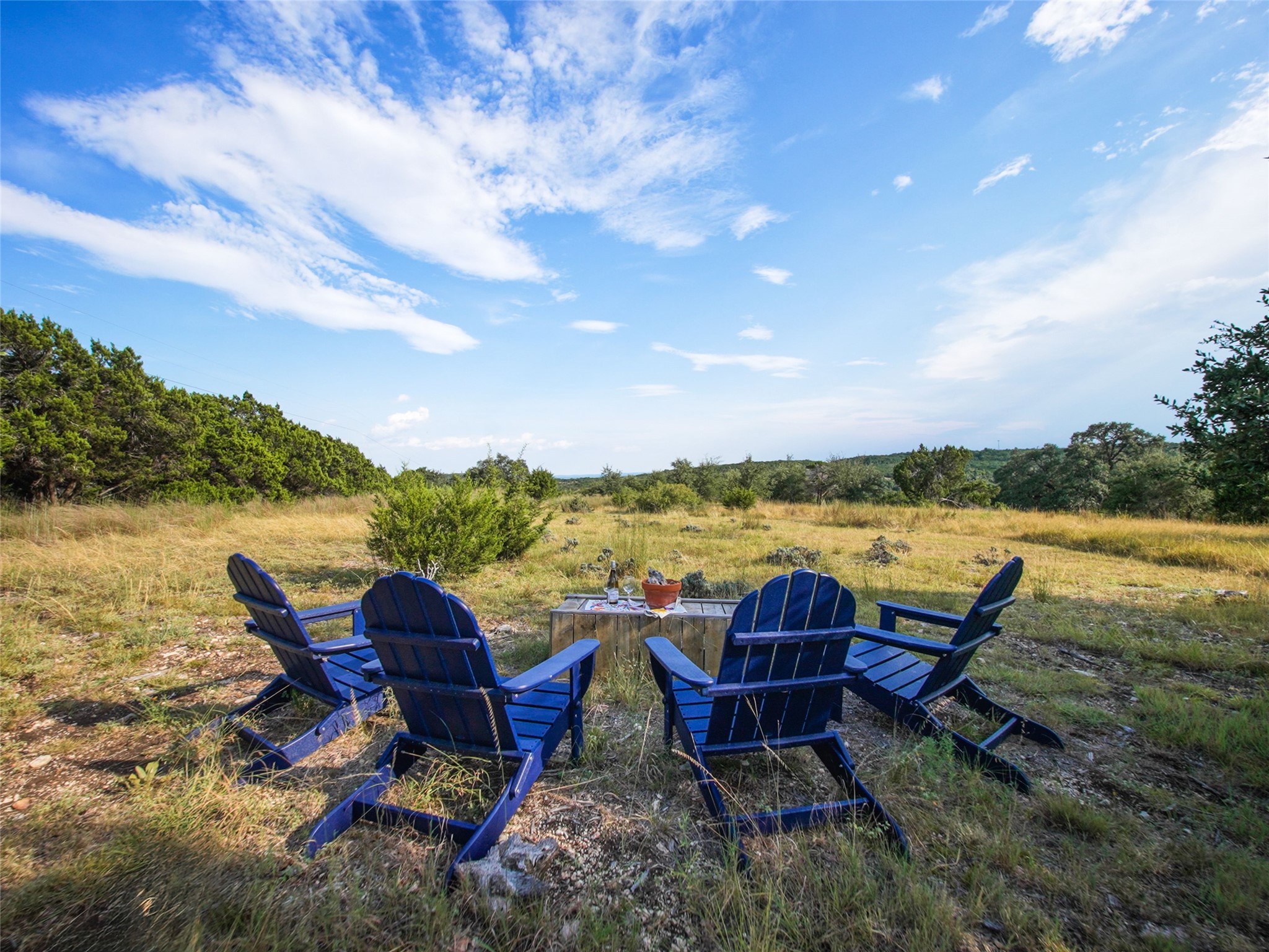 5818 Ranch Road 165 Blanco, TX 78606 - Photo 5 of 20 a view of a lake with table and chairs under an umbrella