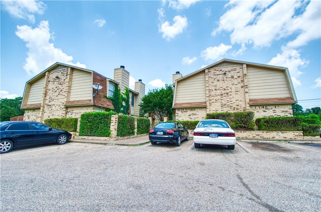 a car parked in front of house with a parking area