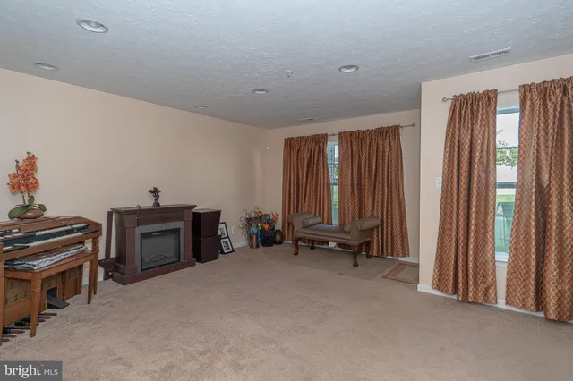 a view of a bedroom with furniture and windows