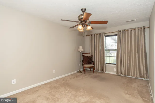 a view of a livingroom with a ceiling fan and a window