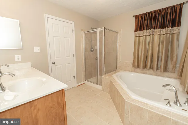 a bathroom with a tub sink and vanity