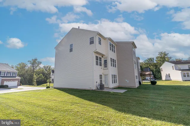 a house view with swimming pool in front of it