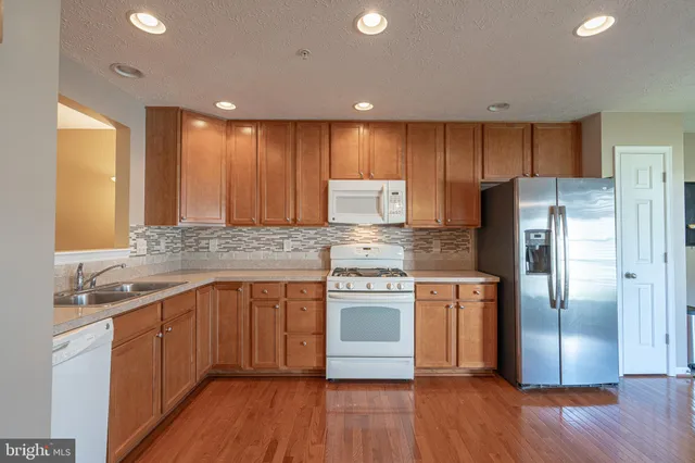 a kitchen with a sink stove and refrigerator
